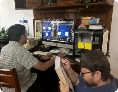 Child writing on board with teacher